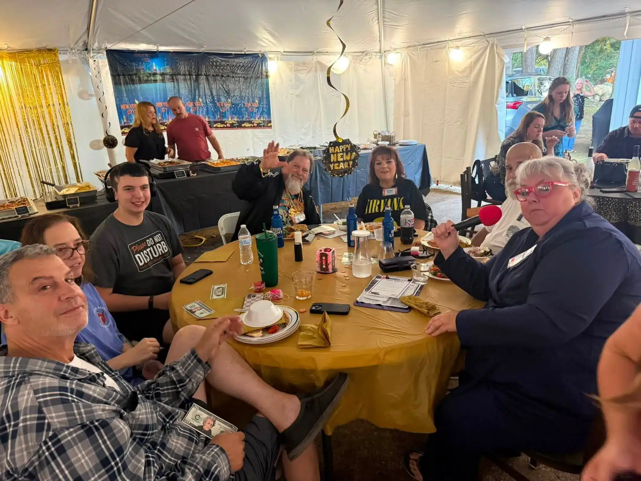Campers enjoying a meal inside the Acorn Acres event tent