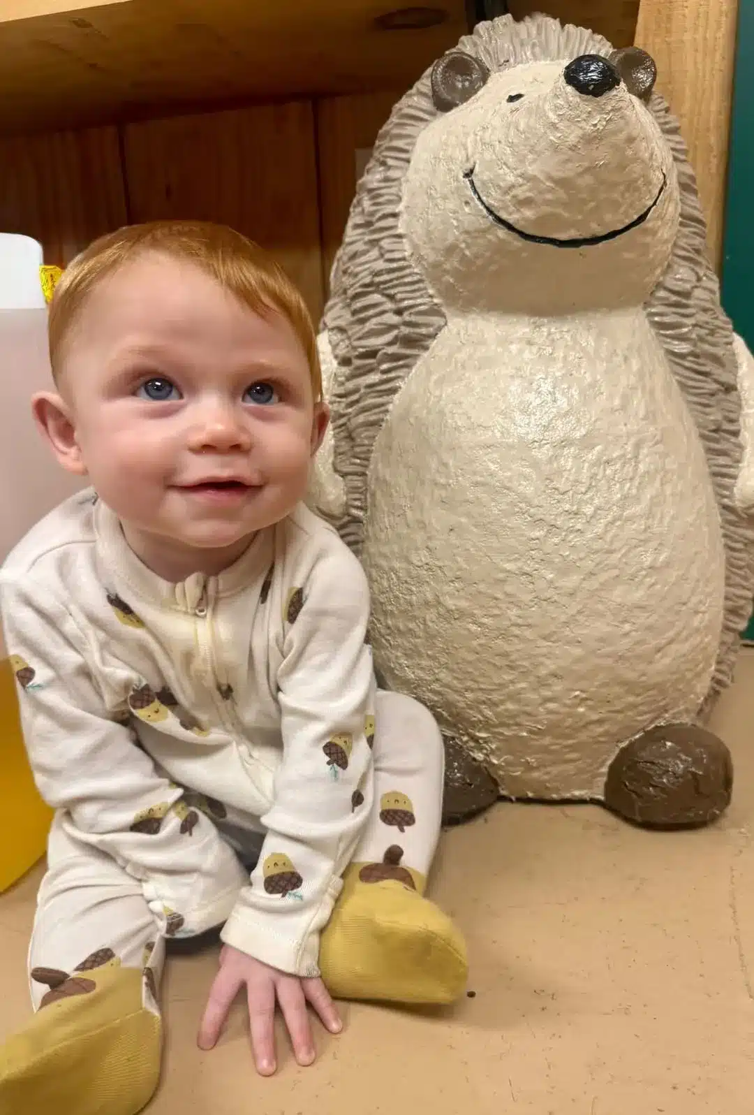 Smiling toddler beside a large plush animal at Acorn Acres Campground in Bozrah, CT