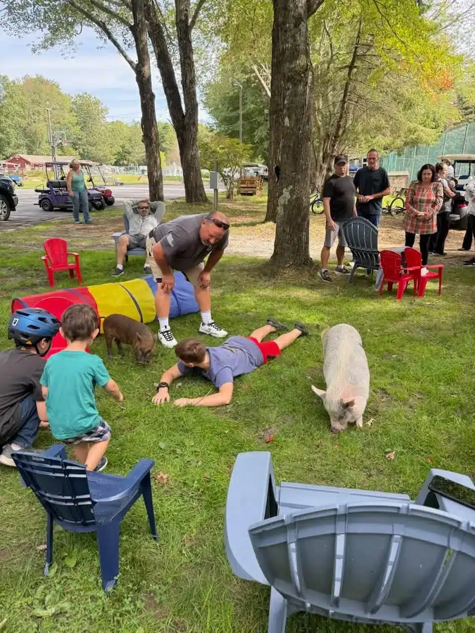 Adults and children gathered on the lawn during an outdoor activity at Acorn Acres Campground, Bozrah CT