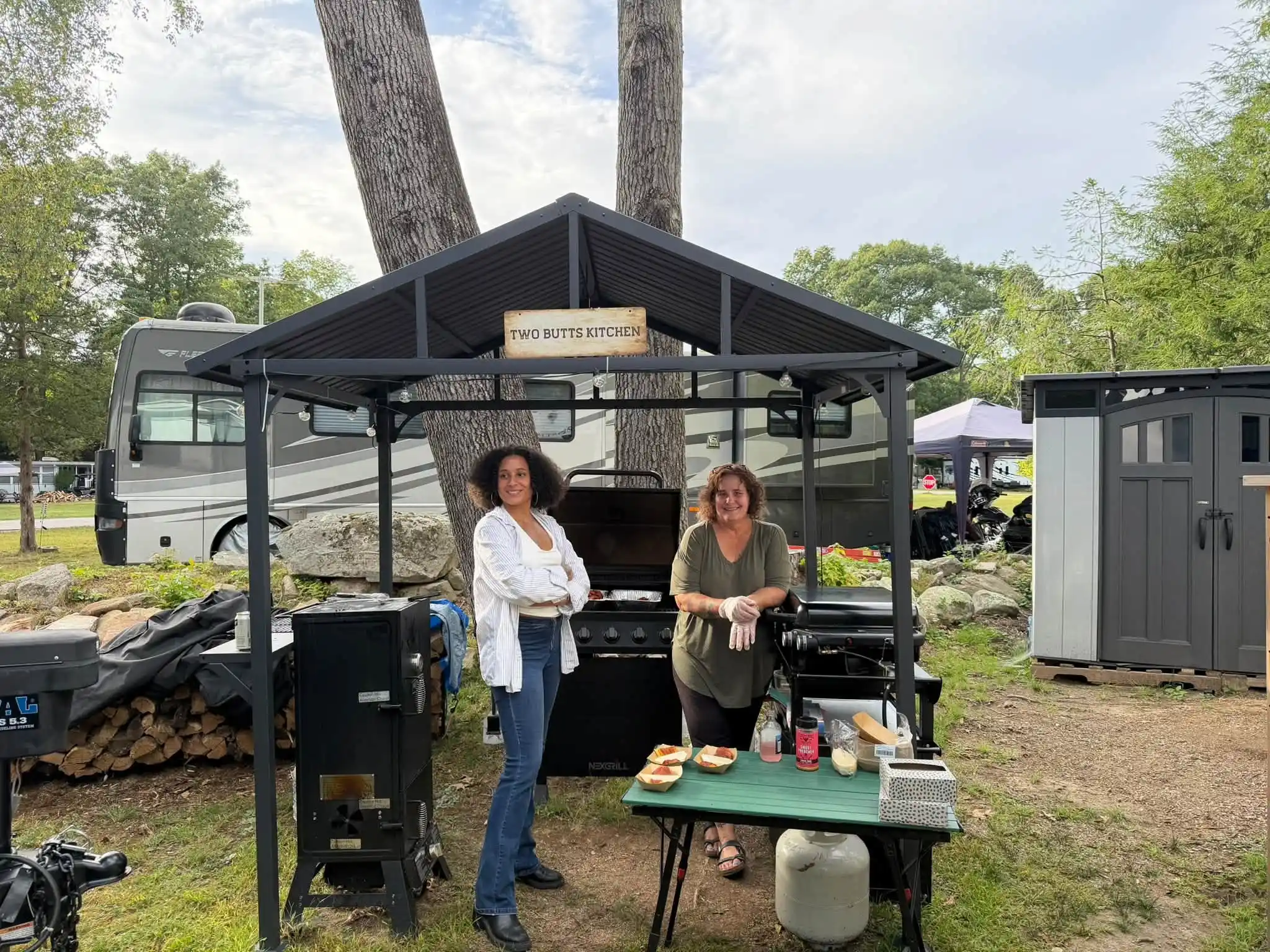 Two women at an outdoor serving station at Acorn Acres Campground, CT